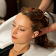© Samo Trebizan - Hair stylist at work - hairdresser washing hair to the customer before doing hairstyle