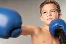 Adorable Boy Boxer Practicing Boxing Punches In Studio