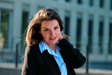 Stylish woman looking to the camera outdoors.