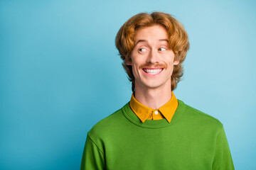 Photo of young handsome funny smiling cheerful positive good mood man look copyspace isolated on blue color background