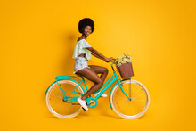 Photo Portrait Full Body Side View Of Woman Riding Bicycle Isolated On Vivid Yellow Colored Background