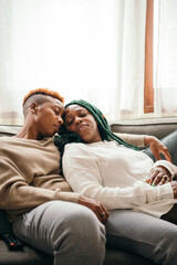 Wall Mural - Happy lesbian couple asleep on the couch