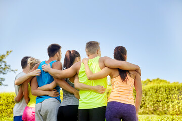 Poster - fitness, sport, friendship and healthy lifestyle concept - group of happy teenage friends hugging outdoors