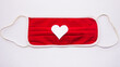 medical red mask with white heart in the middle on white background