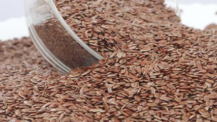 Sticker - Micro rotating shot glass bowl filled with flax seeds, Flax seeds filled in a glass bowl