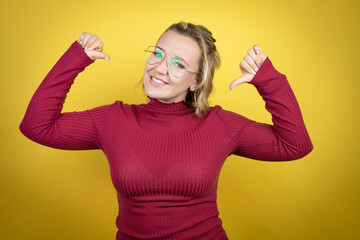 Wall Mural - Young caucasian woman wearing casual red t-shirt over yellow background looking confident with smile on face, pointing oneself with fingers proud and happy.