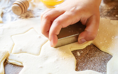 Wall Mural - A child makes a cookie. Selective focus.