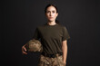 © Drobot Dean - Serious beautiful soldier woman posing with military helmet
