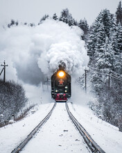 Vertical Shot Of A Train Emitting Smoke In The Forest In The Winter