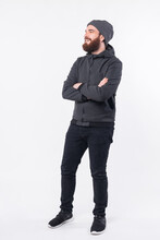 Full Length Photo Of Bearded Man With Crossed Arms Looking A Side.
