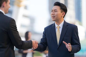 Wall Mural - Close up, Handshake of two businessmen on the background of modern office, partnership concept