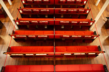 Aerial Photo Up Close Of Red Church Pews With Bibles