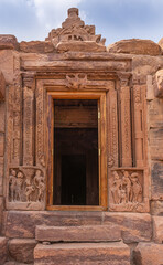 Wall Mural - Bagalakote, Karnataka, India - November 7, 2013: Pattadakal temple complex. Extensive sculptures around Entrance doorway into brown stone Jambulingeshwara temple. Some blue sky,