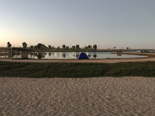 Sticker - Camping tent beside expo 2020 lake. Camping tent with lake background.