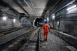worker walking at railway tunnel