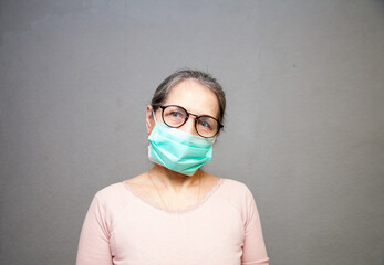 Wall Mural - portrait of senior woman wearing protective medical mask