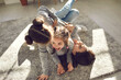 © Studio Romantic - Happy family enjoying quality time at home. Mom and little children frolicking on carpet. Cheerful mother and funny carefree kids playing, laughing and having fun on floor rug in sunny living-room