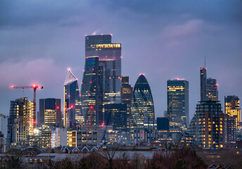 Wall Mural - Cityscape view of the famous financial modern buildings in London illuminated at dusk