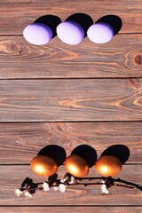 Wall Mural - Easter eggs on brown wooden background