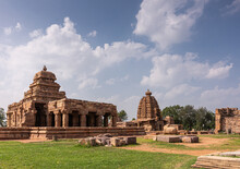 Bagalakote, Karnataka, India - November 7, 2013: Pattadakal Temple Complex. Green Park Landscape Of Brwon Stone Sanganeshwar And Galagnatha Temples Under Blue Cloudscape,