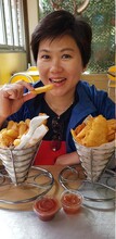 Portrait Of Young Woman Eating Food At Restaurant