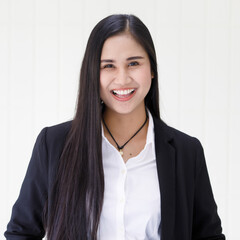 Wall Mural - half body shot of young beautiful and happy Asian woman wearing smart casual smiling with friendly and happy face standing over white background. Confident businesswoman concept