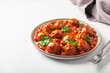 Vegetable meatballs in tomato sauce with beans.