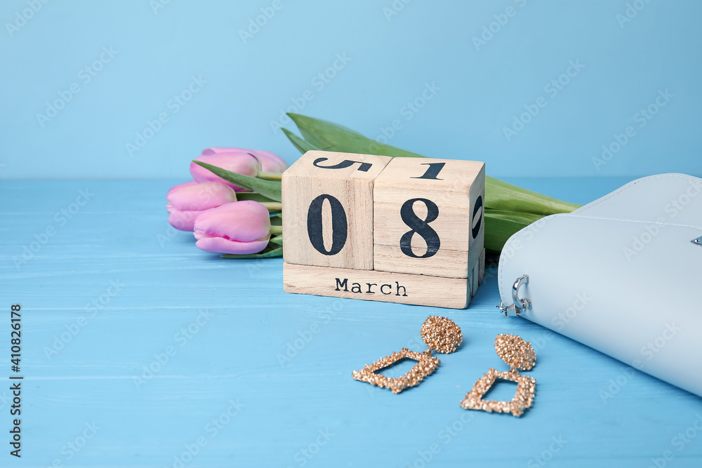 Calendar, flowers and accessories on color background. International Women's Day celebration