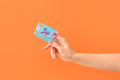 © Pixel-Shot - Female hand with gift card on color background