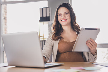 Canvas Print - Photo portrait of pregnant mother holding tablet typing on laptop at desk in modern office