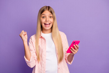 Poster - Photo of optimistic long hairdo pretty girl hold telephone hand fist wear pink shirt isolated on violet color background