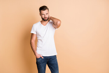 Poster - Portrait of attractive cheery content guy posing copy space isolated over beige pastel color background