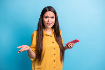 Sticker - Photo of pretty unsatisfied lady sullen face hand hold phone cant understand isolated on blue color background