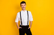 Photo portrait of cheerful positive smiling gentleman wearing shirt suspenders isolated on vibrant yellow color background