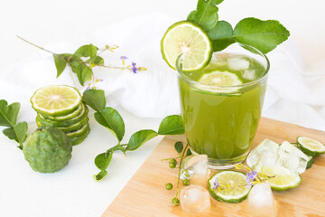 herbal healthy drinks iced kaffir lime cocktail water with bergamot slice local flora of asia decoration flat lay style on background white 