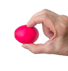 Wall Mural - broken red Easter egg in the hand of an elderly woman is isolated on a white background.