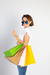 © Анастасия Каргаполов - Studio photo of european woman with shopping bags on white background