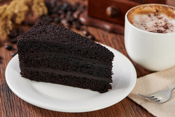 Poster - Delicious chocolate cake and a cup of coffee on a wooden table