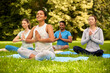© Syda Productions - fitness, sport, yoga and healthy lifestyle concept - group of people meditating in lotus pose at summer park