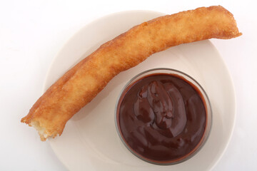 Sticker - fried sugar bars with hot chocolate as typical spanish snack