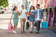 © olenachukhil - Group of people having fun and doing shopping. Friends with shopping bags.