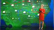 © Gorodenkoff - Live Weather News Studio with Professional Female On-Camera Meteorologist Standing Beside Screen and Making Gestures to Point at Weather Synoptic Map Chart for United States of America