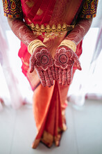 Bride Wearing Sari And Jewelry While Showing Henna Tattoo