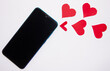 concept social distance Diagonal Mobile phone with red hearts coming out of it on a flat lay with white background
