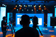© rjankovsky - Professional cameraman - covering on event with a video, cameraman silhouette on live studio news, Selective focus