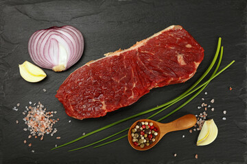 Wall Mural - Raw beef steak meat cut and spices on black board