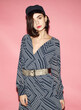 © Sergey Chumakov - fashion model in striped dress and vintage cap isolated on pink background