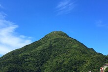 Low Angle View Of Mountain Against Blue Sky
