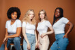 © iordani - young pretty caucasian, afro, scandinavian woman posing cheerful together on brown background, lifestyle diverse nationality people concept