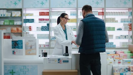 Wall Mural - Pharmacy Drugstore Checkout Cashier Counter: Professional Female Pharmacist Selling Medicine Package, Explains how to Use, Customer Pays Using Contactless Payment Terminal and Credit Card